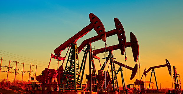Oil pumps pumping oil with a sunset background.